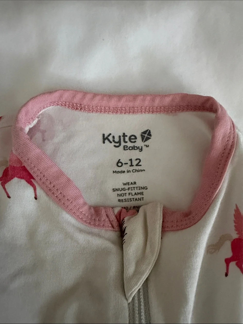 Kyte Baby pink and white unicorn castle print zippy